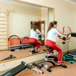 Жінка на велотренажері у тренажерній залі санаторію Аркада у Трускавці