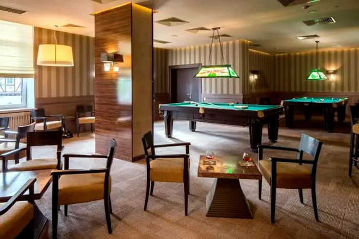 Кімната для більярду в Mirotel Resort & SPA у Трускавці з декількома столами та комфортними меблями