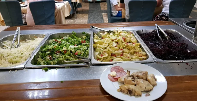 Салат-бар и тарелка с курицей и колбасой в ресторане курортного комплекса в Трускавце